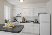 Washington apartment for rent - A kitchen with white cabinets and appliances.