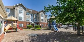 Suitland apartment for rent - a group of colorful wooden signs in a park at Windsor Crossing, Maryland 
