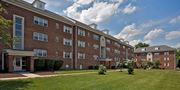 Silver Spring apartment for rent - A large red brick building with a green lawn in front. at University Landing Apartments, Silver Spring, MD