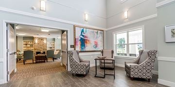 Mount Rainier apartment for rent - A living room with a large painting on the wall and a view of a kitchen through the open door.