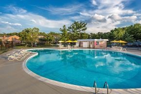 Greenbelt apartment for rent - A large outdoor swimming pool with a yellow umbrella at Charlestowne North Apartments, Greenbelt, Maryland
