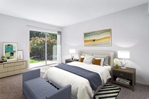 Frederick apartment for rent - bedroom at Creekside at Taskers Chance in Frederick, MD with bed with white and blue linens, bedroom bench, nighttables and dresser