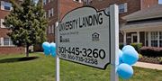 Silver Spring apartment for rent - A sign for University Landing is displayed in front of a building. at University Landing Apartments, Silver Spring, MD, 20903