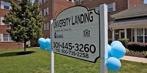 Silver Spring apartment for rent - A sign for University Landing is displayed in front of a building. at University Landing Apartments, Silver Spring, MD, 20903
