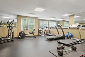 Suitland apartment for rent - A gym with treadmills, elliptical machines, and weights.