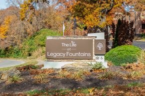 Kansas City apartment for rent - A sign that says "The Life at Legacy Fountains" is in front of a building.