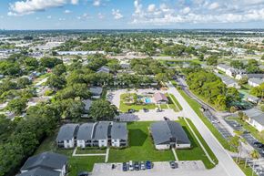 Largo apartment for rent - A bird's eye view of a residential area with houses, trees, and a parking lot.