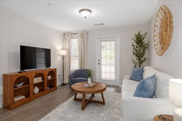 Conyers apartment for rent - A living room with a white couch and a wooden coffee table.