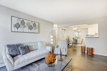 Denver apartment for rent - A living room with a white couch and a grey coffee table.