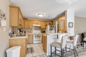Asheville apartment for rent - A kitchen with wooden cabinets and a white refrigerator.