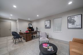 Smyrna apartment for rent - A modern office space with a desk, chairs, and pictures on the wall.