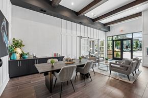 Knightdale apartment for rent - A modern dining room with a wooden table and grey chairs.