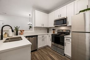 Beaufort apartment for rent - A modern kitchen with white cabinets and stainless steel appliances.