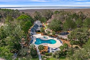Beaufort apartment for rent - A house with a pool surrounded by trees.