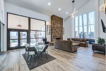 Phoenix apartment for rent - A modern living room with a glass table and chairs.