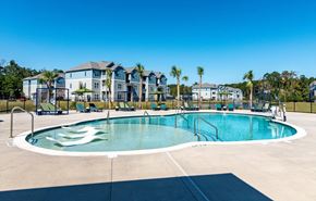 Summerville apartment for rent - A swimming pool with a white lounge chair in the pool.