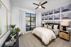 Suwanee apartment for rent - a bedroom with a bed and a ceiling fan