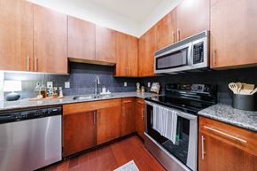 Atlanta apartment for rent - A kitchen with wooden cabinets and stainless steel appliances.
