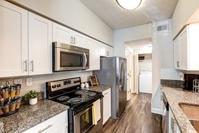 Sandy Springs apartment for rent - a kitchen with stainless steel appliances and granite counter tops  at Flats at North Springs, Sandy Springs, GA, 30328