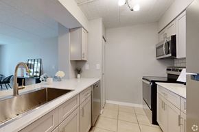 Largo apartment for rent - A kitchen with a sink, stove, and microwave.