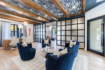 Smyrna apartment for rent - A living room with blue chairs and a wooden ceiling.