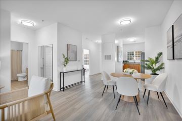 Leland apartment for rent - A modern living room with a dining table and chairs.