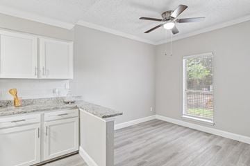 Euless townhouse for rent - A kitchen with white cabinets and a marble countertop.