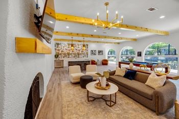 A living room with couches and chairs and a fireplace
