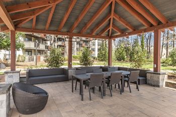 A patio with tables and chairs under a roof