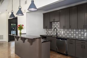 Birmingham apartment for rent - A kitchen with a dark counter and cabinets.