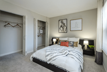 A bedroom with a large bed and a closet