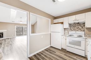 Asheville apartment for rent - an empty kitchen with white appliances and white cabinets
