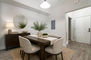 Goose Creek apartment for rent - A dining room with a wooden table and white chairs.