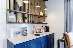 Smyrna apartment for rent - A kitchen with blue cabinets and a white countertop.