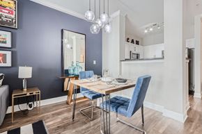 Atlanta apartment for rent - A dining room with a blue chair and a wooden table.