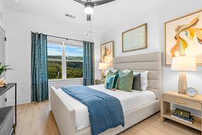 Arden apartment for rent - A bedroom with a large bed and a ceiling fan.