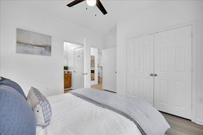 Leland apartment for rent - A bedroom with a large bed and a ceiling fan.