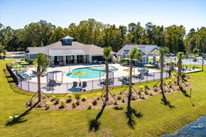 Summerville apartment for rent - A pool deck with palm trees.