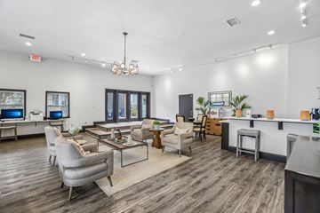 Doraville apartment for rent - A modern living room with a grey sofa set and a wooden floor.