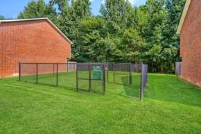 Commerce townhouse for rent - A green sign is on a fence in a grassy yard.