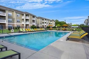 Leland apartment for rent - A swimming pool in front of apartment buildings.