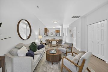 Wilmington townhouse for rent - A living room with a grey couch and a round mirror on the wall.