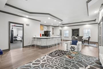 Columbus apartment for rent - A modern living room with a grey rug and a white dining table.