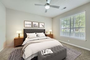Kennesaw apartment for rent - A bedroom with a large bed and a ceiling fan.
