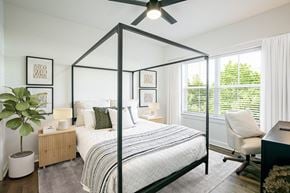 Murfreesboro apartment for rent - a bedroom with a large bed and a ceiling fan
