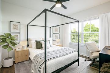 Murfreesboro apartment for rent - a bedroom with a large bed and a ceiling fan