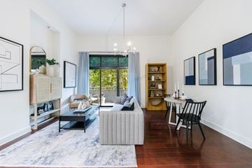 Atlanta apartment for rent - A living room with a grey sofa and a black chair.