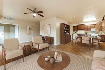 Altoona apartment for rent - A living room with a brown coffee table and beige chairs.
