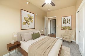 Altoona apartment for rent - A bedroom with a large bed and a ceiling fan.