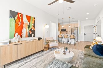 Arden apartment for rent - A living room with a large painting on the wall and a wooden cabinet.